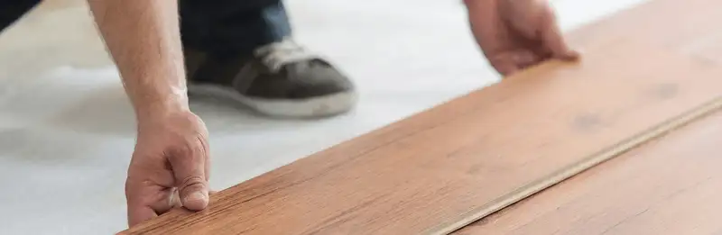 A professional installing laminate flooring in Cape Coral, FL